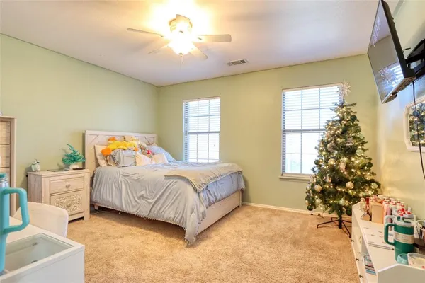a bedroom with a bed and a chandelier