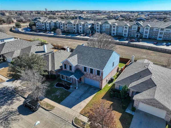 an aerial view of a house with a yard
