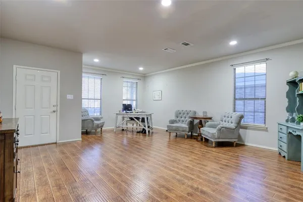 a living room with furniture and wooden floor