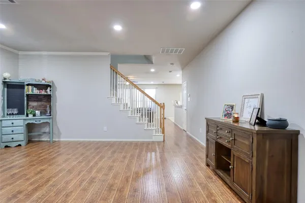 a view of a workspace with furniture and wooden floor