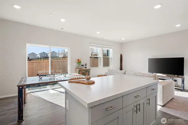 a kitchen with stainless steel appliances a refrigerator sink and wooden floor