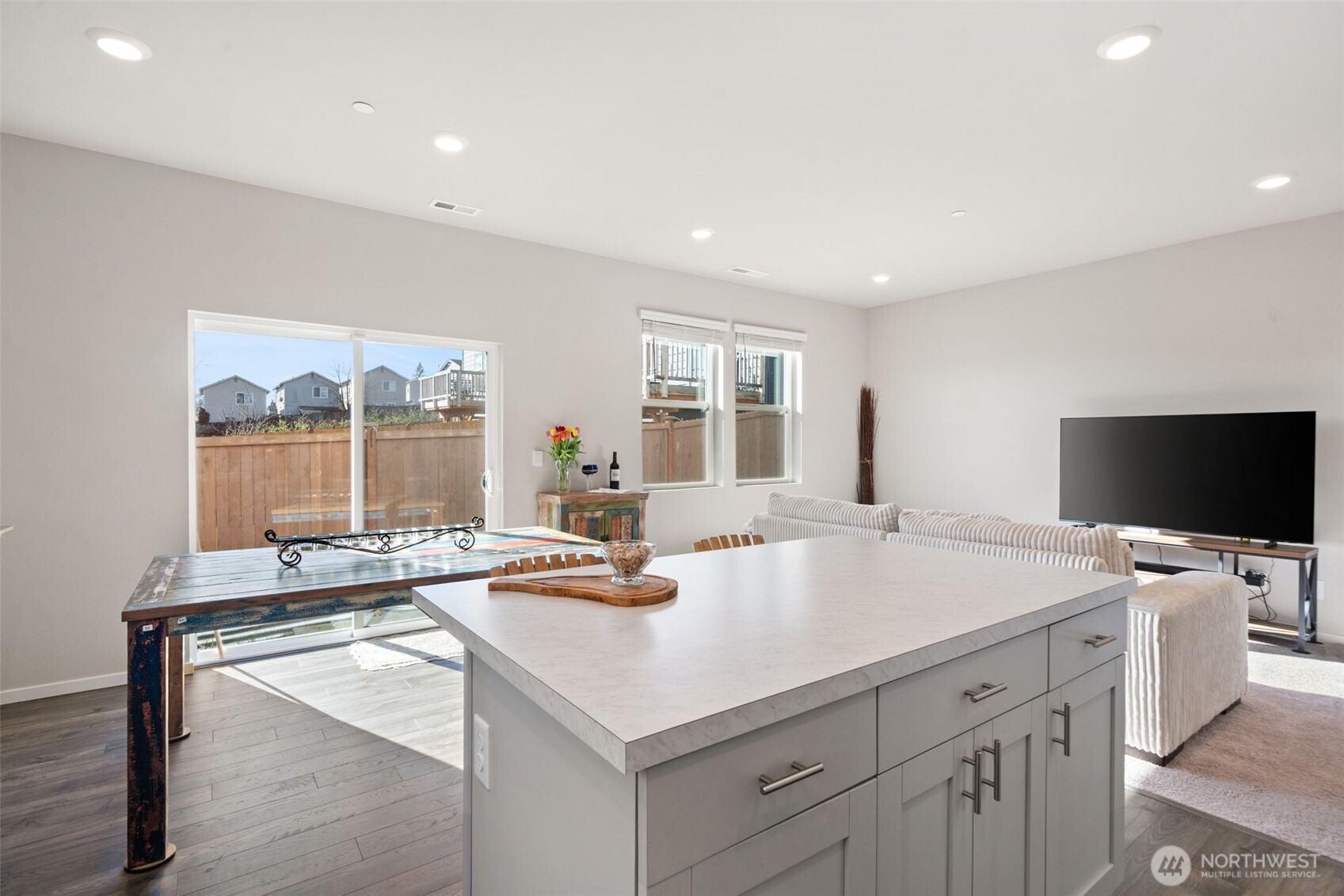 949 Tetherow Street Bremerton, WA 98310 - Photo 11 of 35 a room with a table chairs and flat screen tv