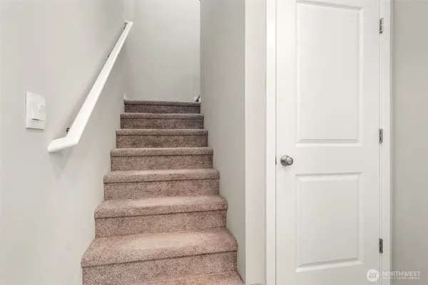 an empty room with windows and wooden door
