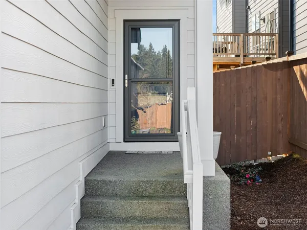 a view of a door and wooden floor in front of house