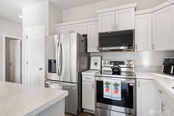 a kitchen with a sink cabinets and stainless steel appliances