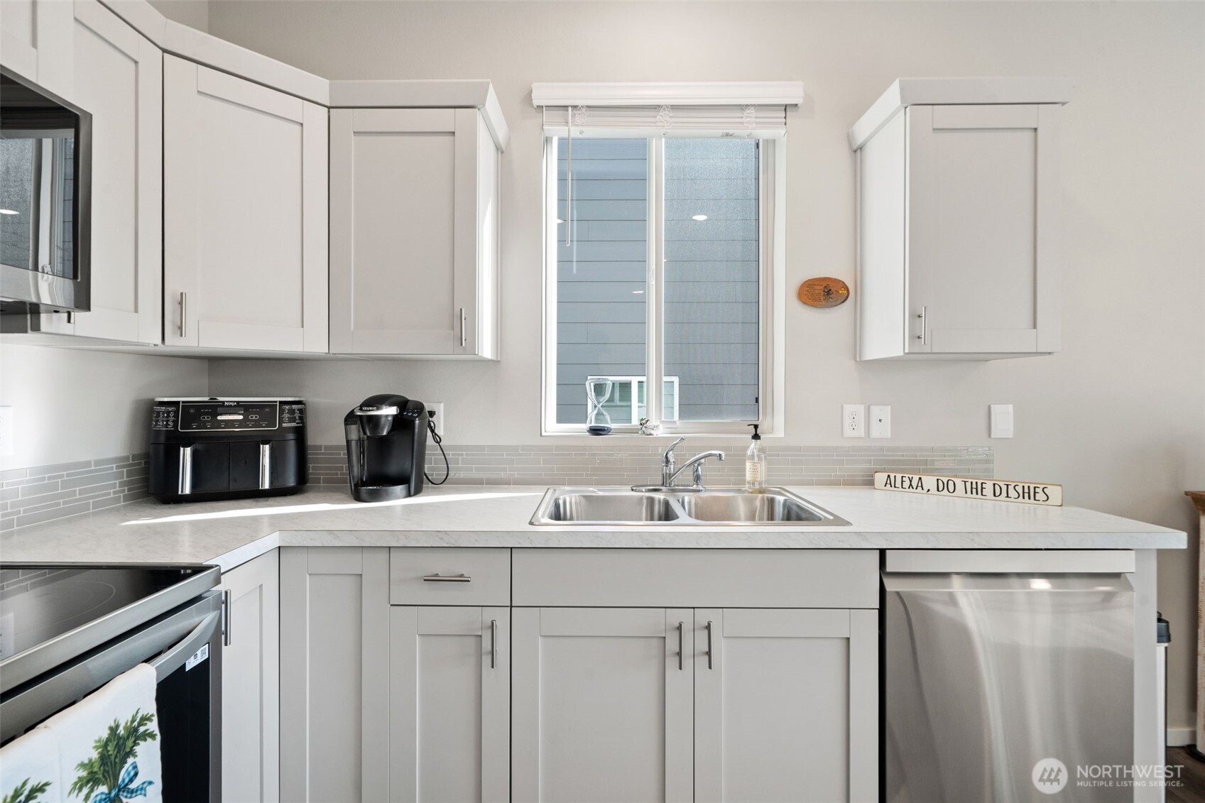 949 Tetherow Street Bremerton, WA 98310 - Photo 10 of 35 a kitchen with a sink cabinets and stainless steel appliances