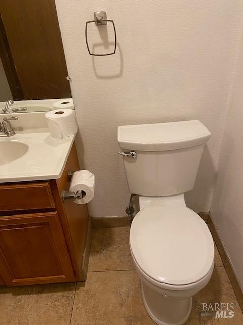 1565 Parkway Drive Rohnert Park, CA 94928 - Photo 17 of 25 a white toilet sitting next to a bathroom sink and vanity