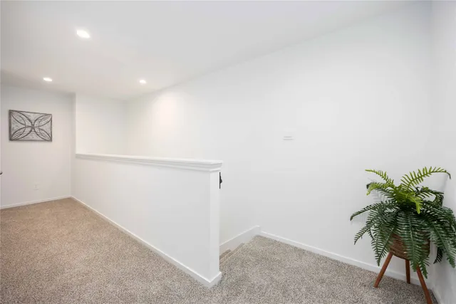an empty room with potted plants and wooden floor