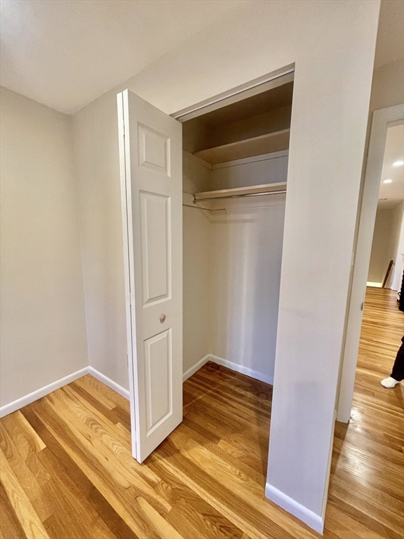 77 Louise Road, Unit 77 Newton, MA 02467 - Photo 13 of 22 a view of a room with wooden floor and a door