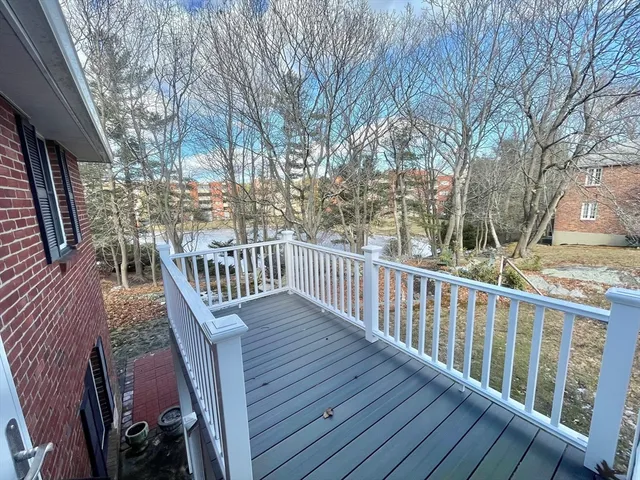 a view of balcony with wooden floor and fence