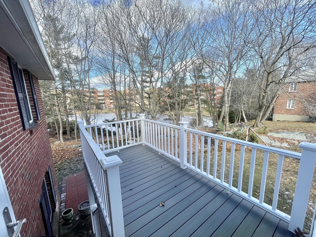 77 Louise Road, Unit 77 Newton, MA 02467 - Photo 21 of 22 a view of balcony with wooden floor and fence