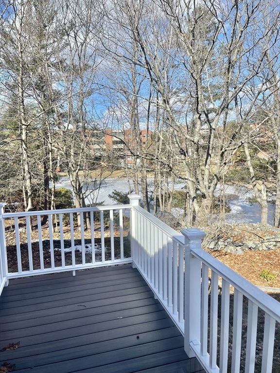 77 Louise Road, Unit 77 Newton, MA 02467 - Photo 22 of 22 a view of a balcony with wooden fence and large trees