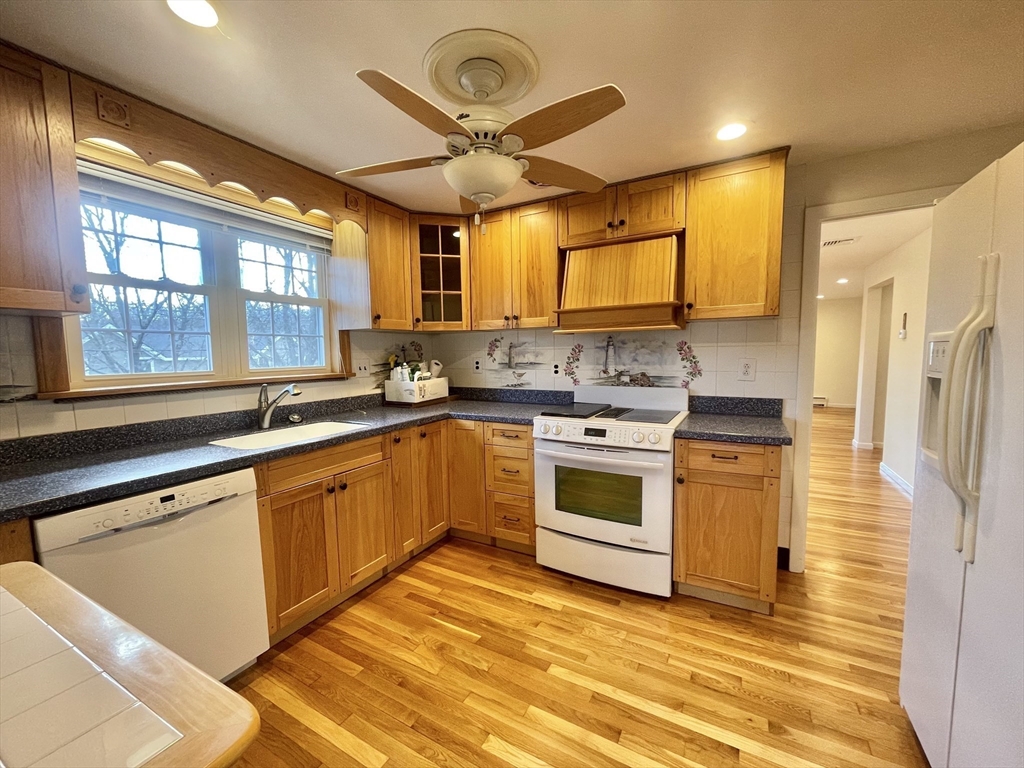 77 Louise Road, Unit 77 Newton, MA 02467 - Photo 5 of 22 a kitchen with stainless steel appliances granite countertop a stove a sink and a refrigerator