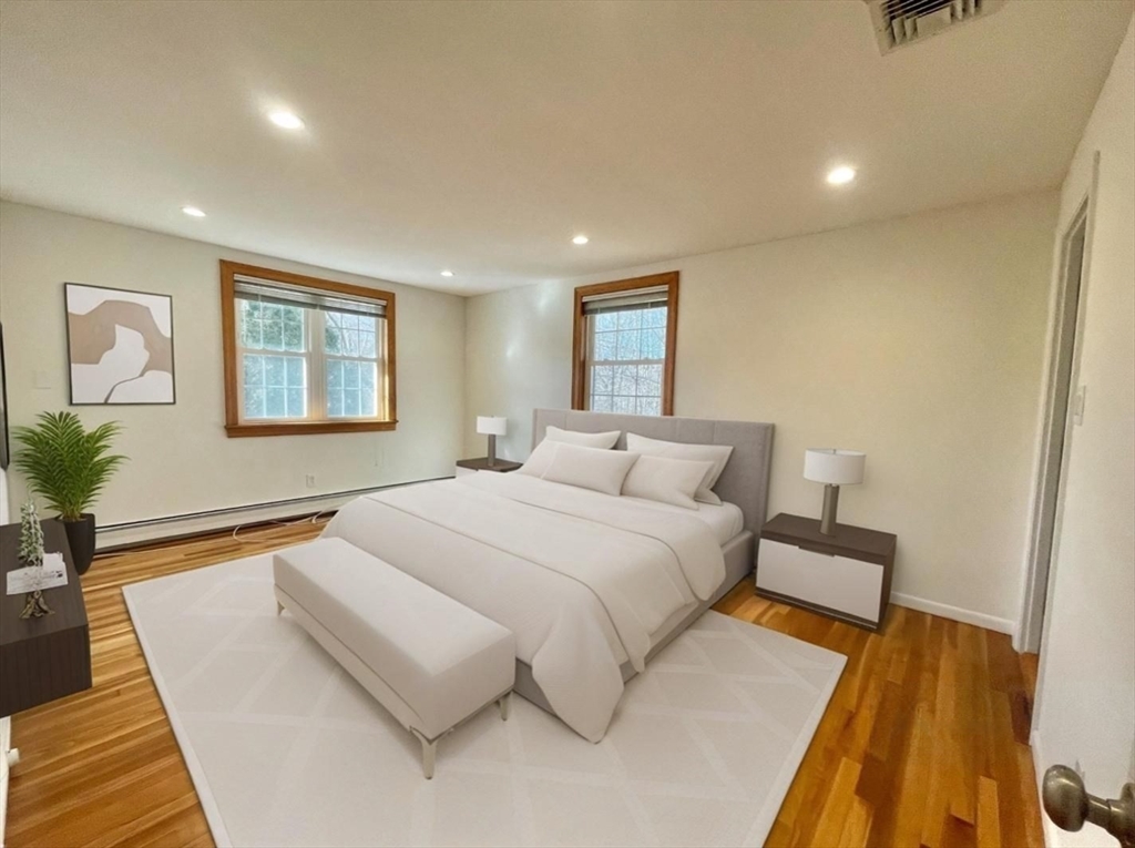 77 Louise Road, Unit 77 Newton, MA 02467 - Photo 7 of 22 a bedroom with a bed and a couch