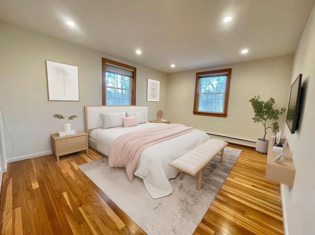 77 Louise Road, Unit 77 Newton, MA 02467 - Photo 9 of 22 a spacious bedroom with a bed and a flat screen tv