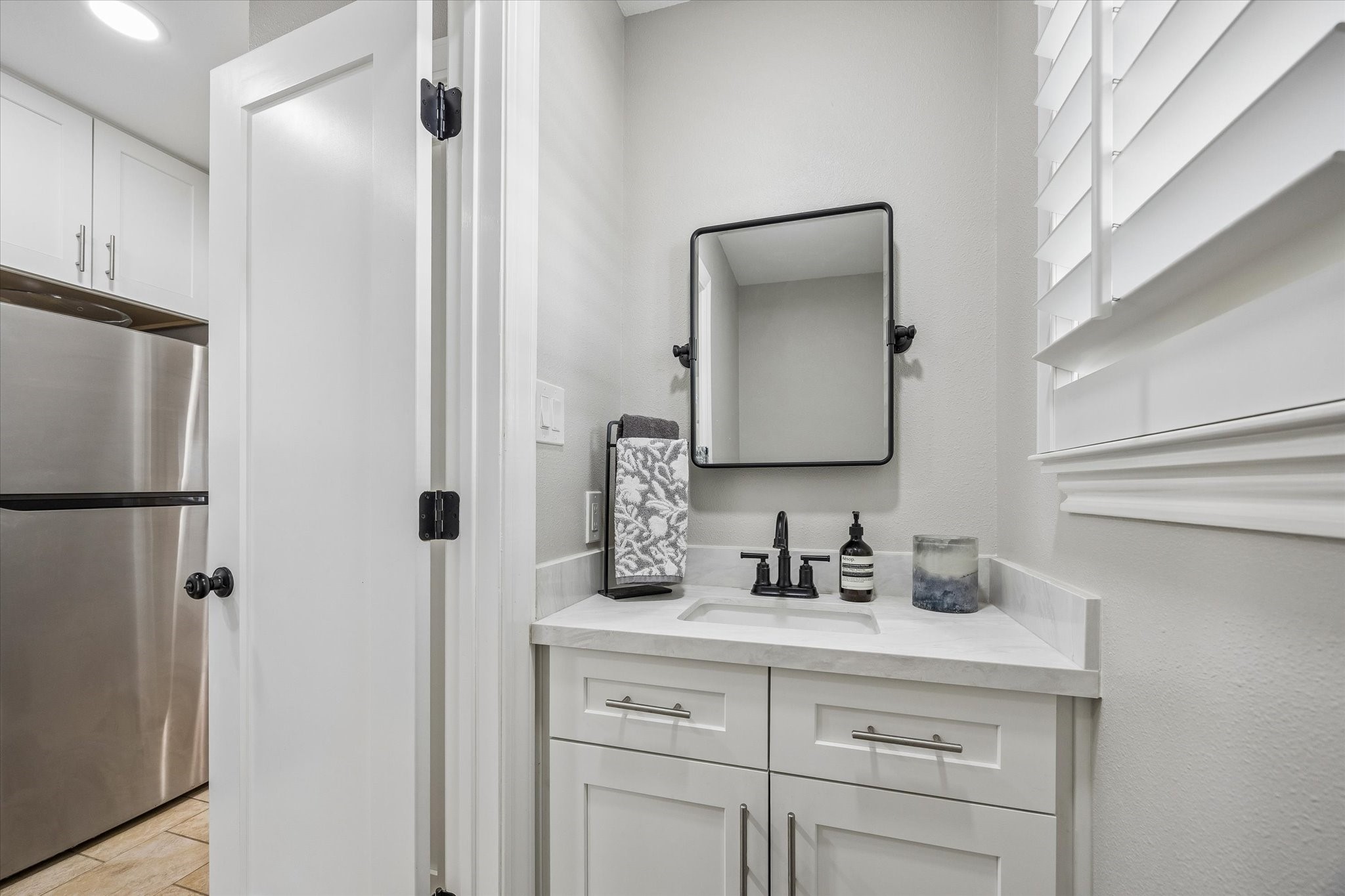 13926 Perthshire Road Houston, TX 77079 - Photo 20 of 31 Updated half bath off the utility room offers guest privacy and provides easy access from the patio when entertaining outdoors.