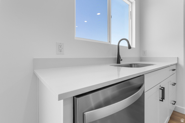 1355 West 2350 South, Unit 11 Perry, UT 84302 - Photo 10 of 39 Crisp white cabinetry with matte black hardware, a stainless steel under-mount sink, and a gooseneck faucet