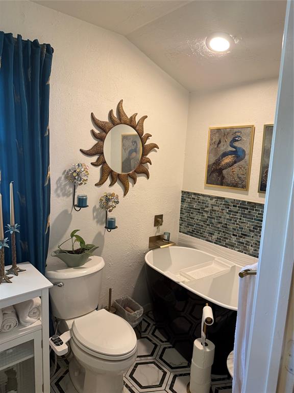 1650 Azteca Drive Fort Worth, TX 76112 - Photo 11 of 37 a bathroom with a sink a toilet a mirror and vanity