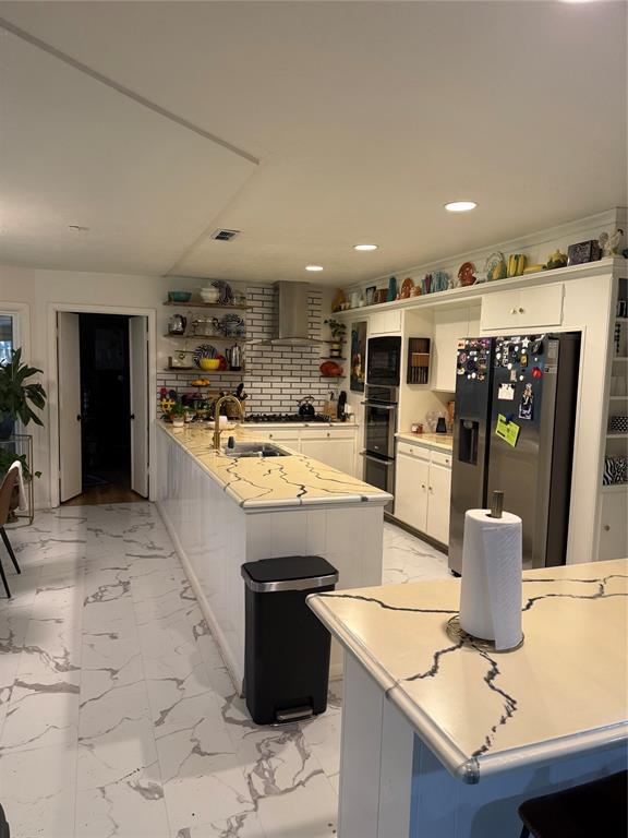 1650 Azteca Drive Fort Worth, TX 76112 - Photo 19 of 37 a large kitchen with kitchen island a sink stove and refrigerator