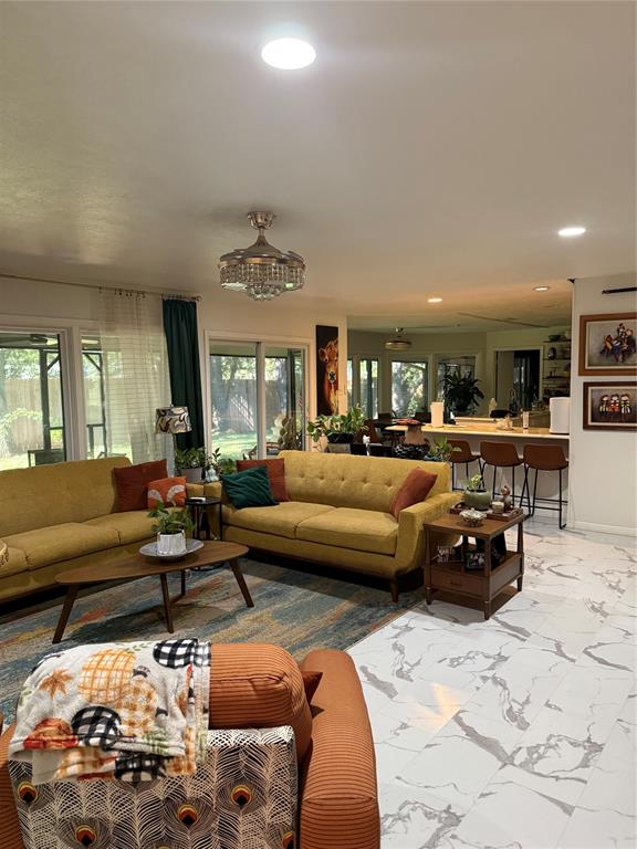 1650 Azteca Drive Fort Worth, TX 76112 - Photo 24 of 37 a living room with furniture and a chandelier
