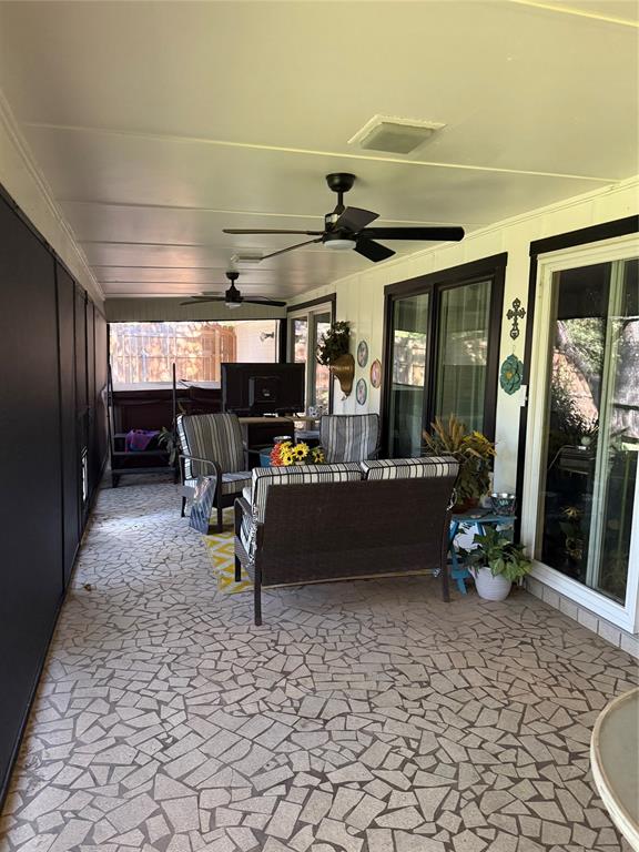 1650 Azteca Drive Fort Worth, TX 76112 - Photo 35 of 37 a living room with furniture a flat screen tv and a table