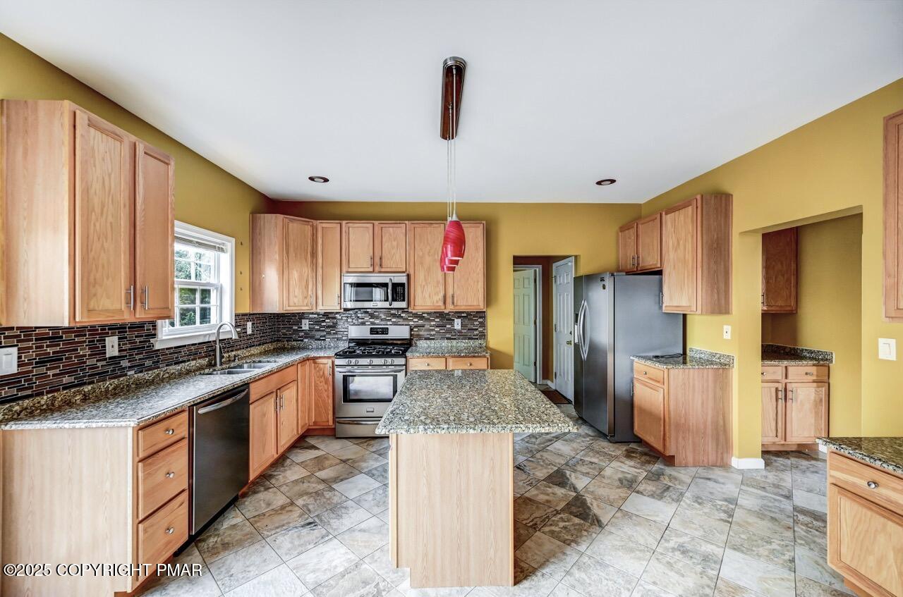 115 Daffodil Drive East Stroudsburg, PA 18301 - Photo 12 of 59 a large kitchen with stainless steel appliances granite countertop a stove refrigerator and a sink