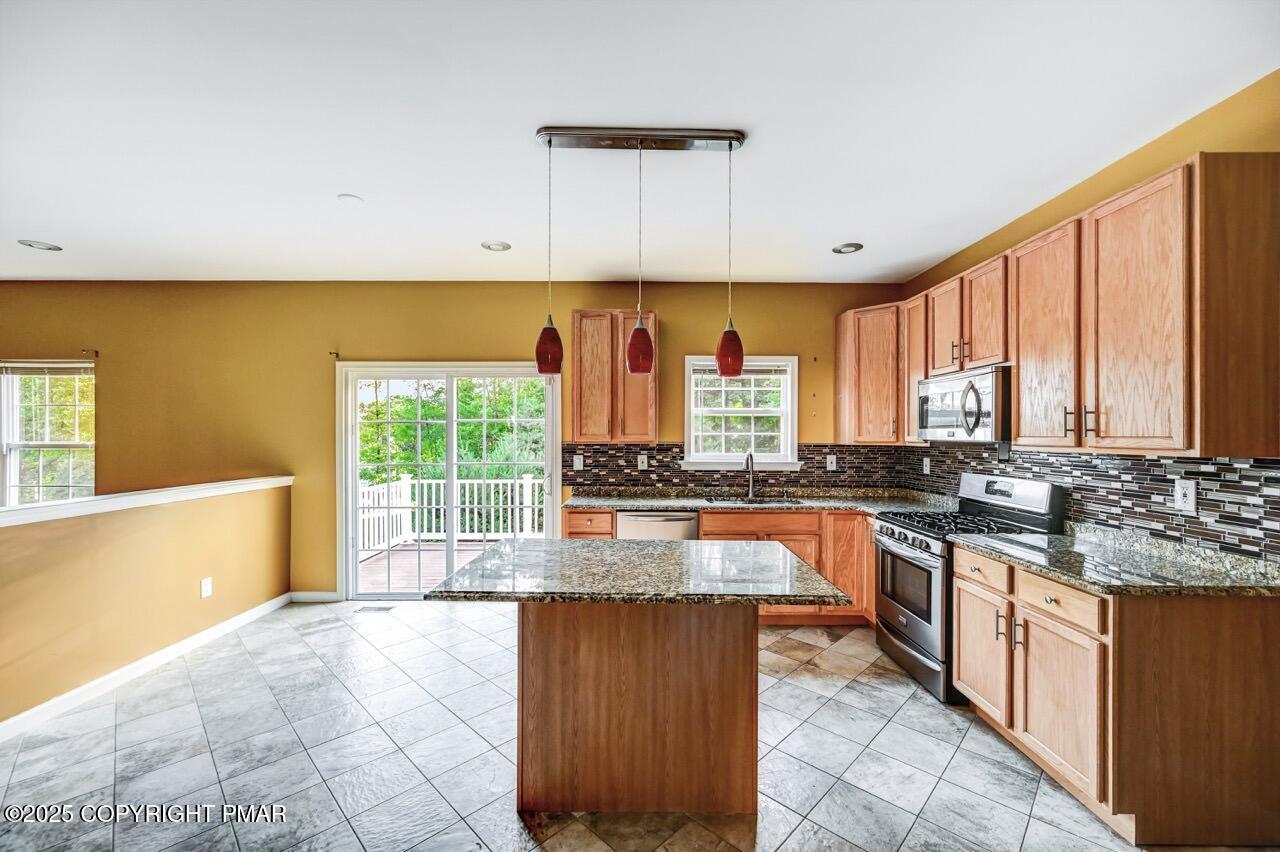 115 Daffodil Drive East Stroudsburg, PA 18301 - Photo 13 of 59 a large kitchen with kitchen island granite countertop a large window and a counter space