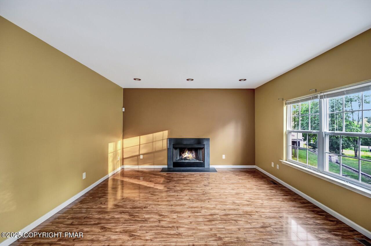 115 Daffodil Drive East Stroudsburg, PA 18301 - Photo 16 of 59 a view of an empty room with a fireplace and a window