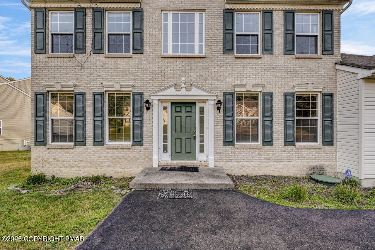 115 Daffodil Drive East Stroudsburg, PA 18301 - Photo 2 of 59 a front view of a house with a garden and plants