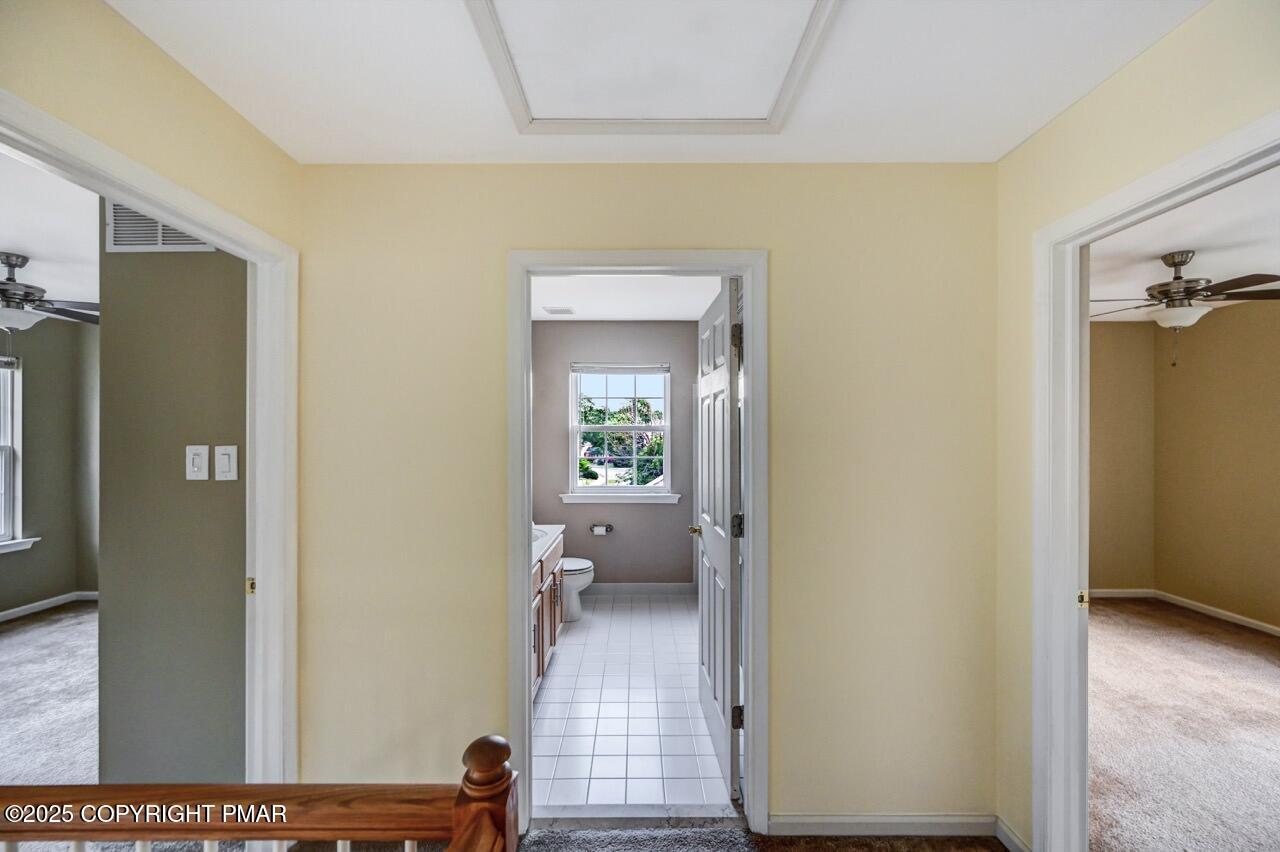 115 Daffodil Drive East Stroudsburg, PA 18301 - Photo 37 of 59 a view of a hallway with wooden floor and a living room