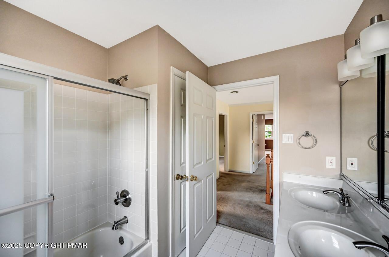 115 Daffodil Drive East Stroudsburg, PA 18301 - Photo 43 of 59 a bathroom with a granite countertop shower sink and mirror