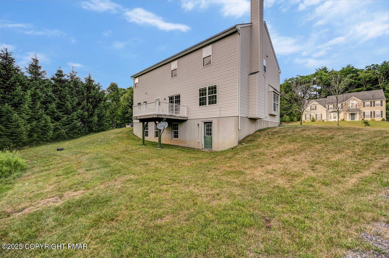 115 Daffodil Drive East Stroudsburg, PA 18301 - Photo 54 of 59 a view of a white house with a big yard and large tree