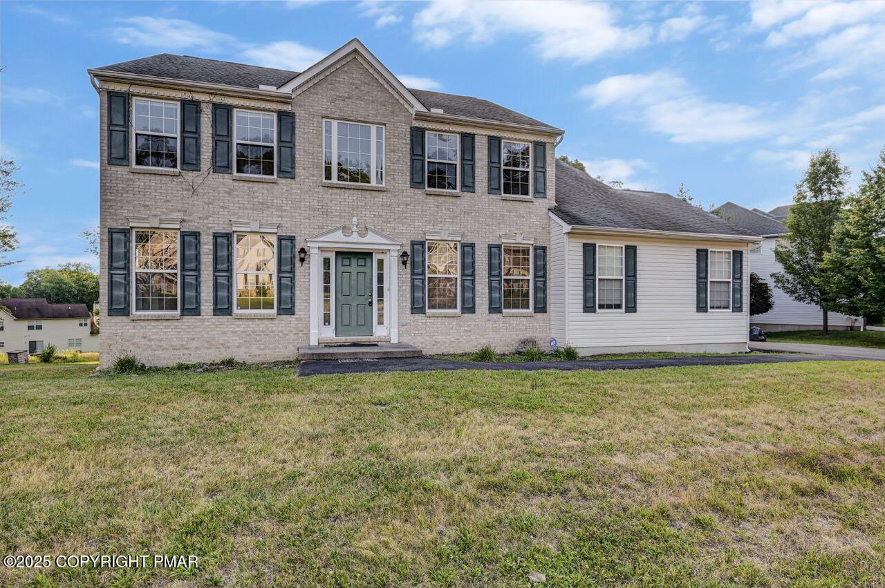 115 Daffodil Drive East Stroudsburg, PA 18301 - Photo 57 of 59 a front view of a house with a garden