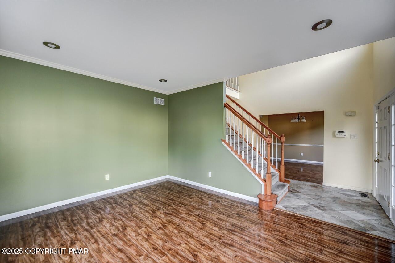 115 Daffodil Drive East Stroudsburg, PA 18301 - Photo 6 of 59 a view of a room with wooden floor and stairs