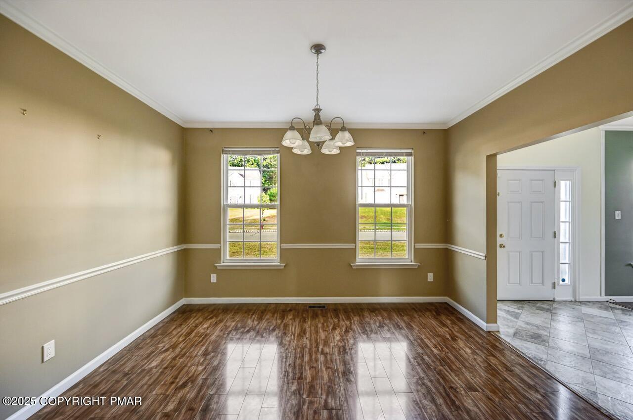 115 Daffodil Drive East Stroudsburg, PA 18301 - Photo 8 of 59 a view of an empty room with window and wooden floor