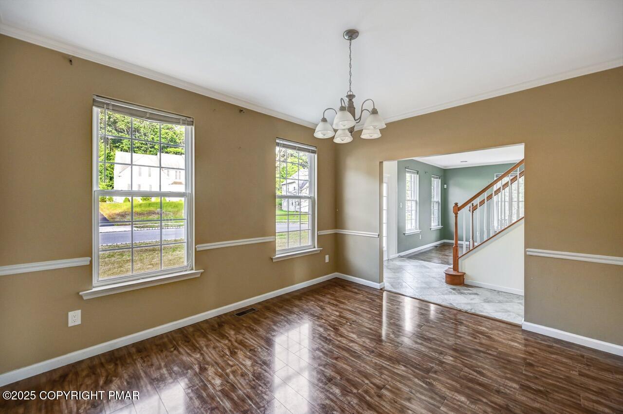 115 Daffodil Drive East Stroudsburg, PA 18301 - Photo 9 of 59 a view of an empty room with wooden floor and a window