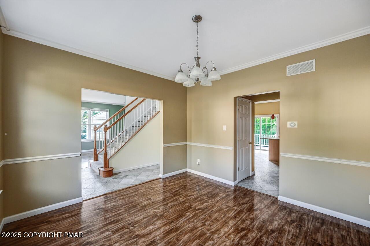 115 Daffodil Drive East Stroudsburg, PA 18301 - Photo 10 of 59 a view of a livingroom with wooden floor and staircase