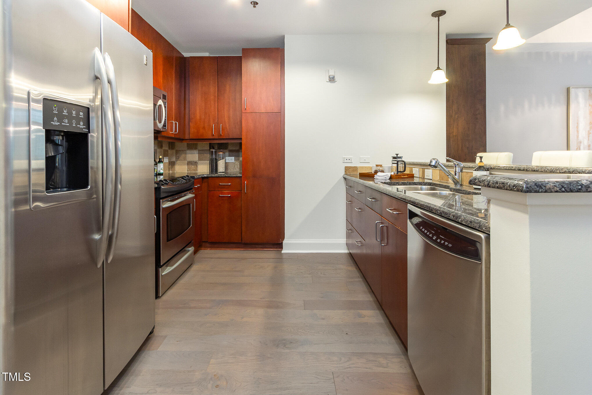618 North Boylan Avenue, Unit 520 Raleigh, NC 27603 - Photo 9 of 27 a kitchen with stainless steel appliances granite countertop a stove a refrigerator and a sink