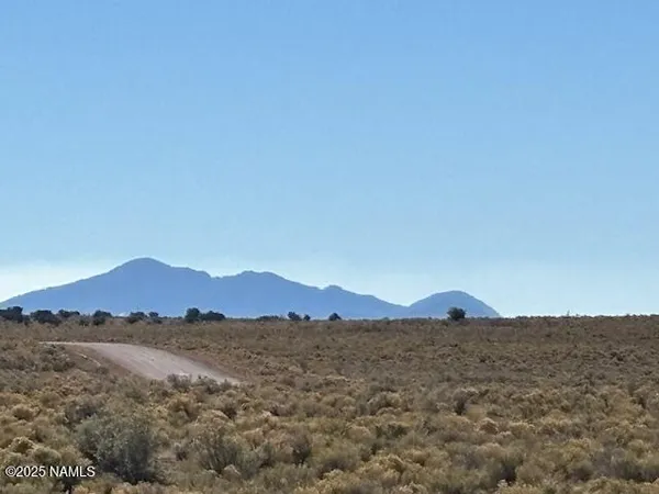 a view of mountains and valleys in the background