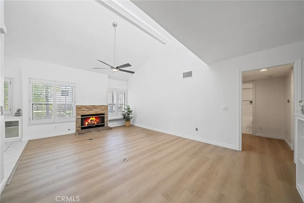 4277 Las Virgenes Road Calabasas, CA 91302 - Photo 1 of 28 Open spacious living room with a cozy fireplace and vaulted ceilings.