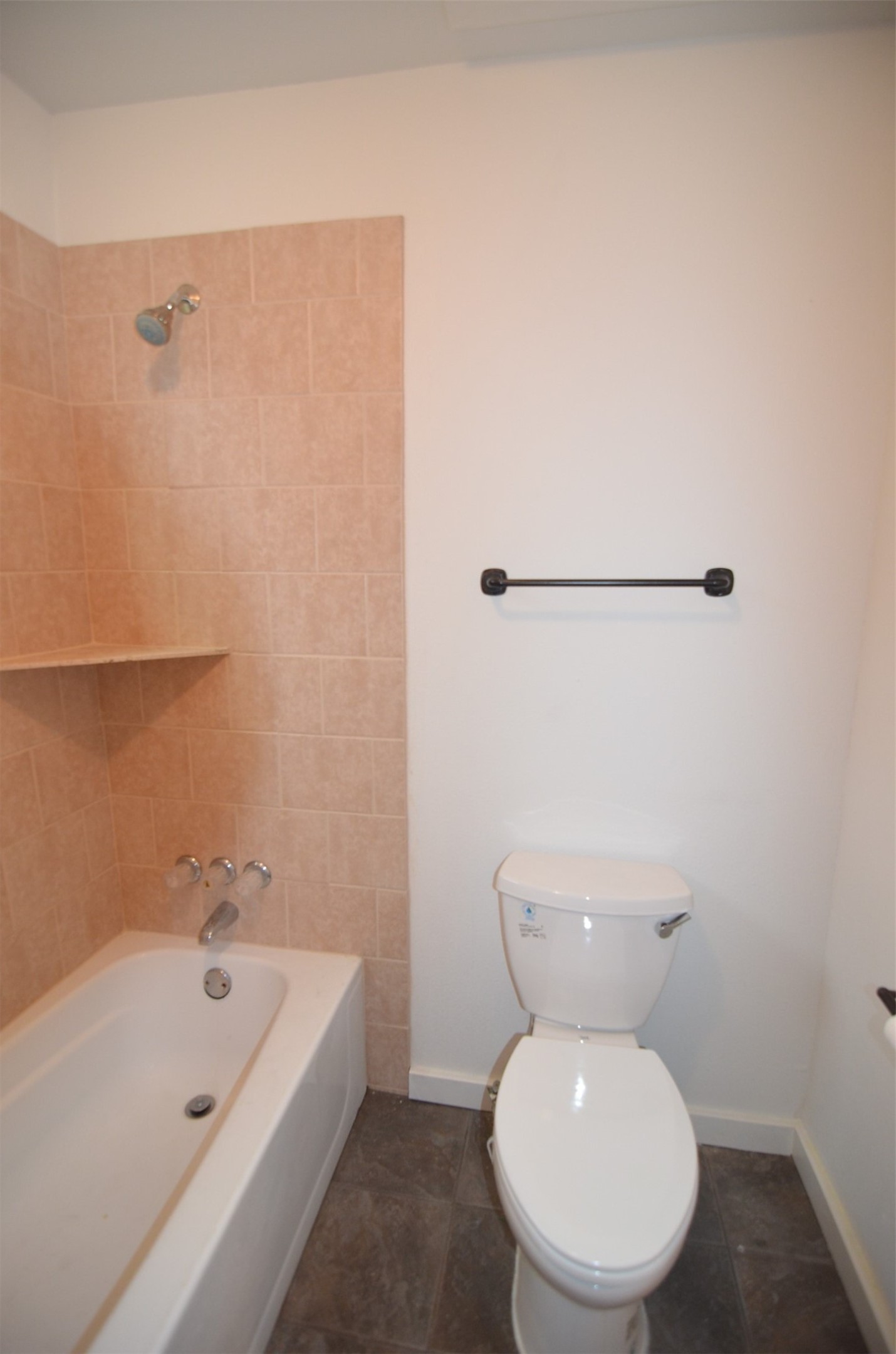 2123 Marion Street, Unit 1 Houston, TX 77009 - Photo 14 of 19 a white toilet sitting next to a bath tub