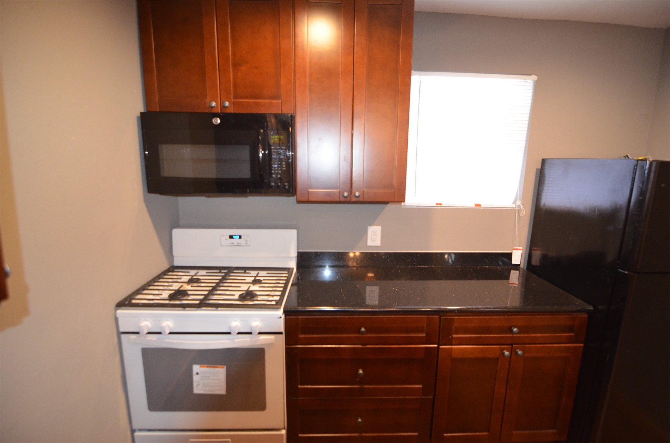 2123 Marion Street, Unit 1 Houston, TX 77009 - Photo 4 of 19 a kitchen with a stove and a microwave