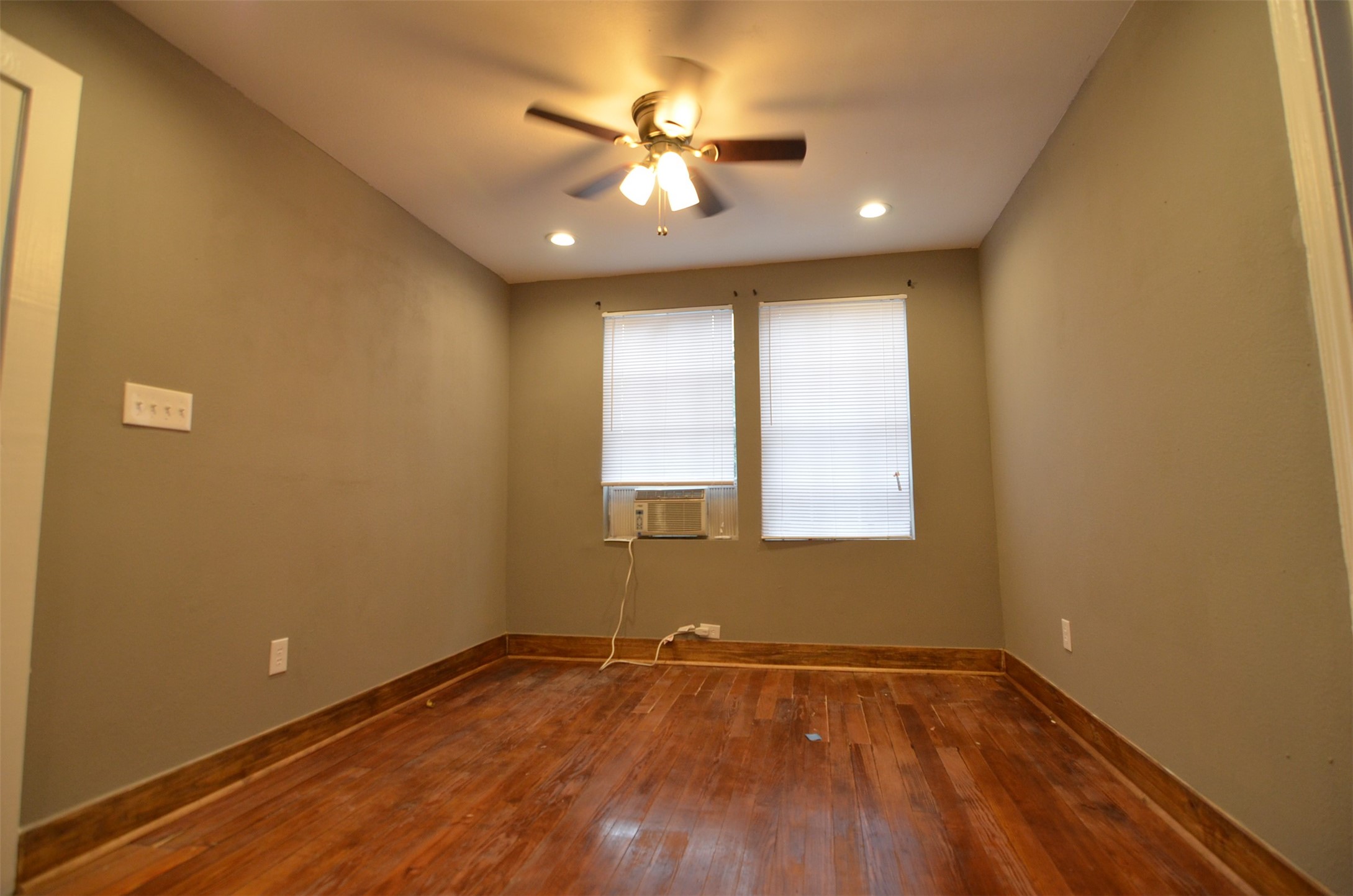 2123 Marion Street, Unit 1 Houston, TX 77009 - Photo 7 of 19 a view of an empty room with wooden floor and a window