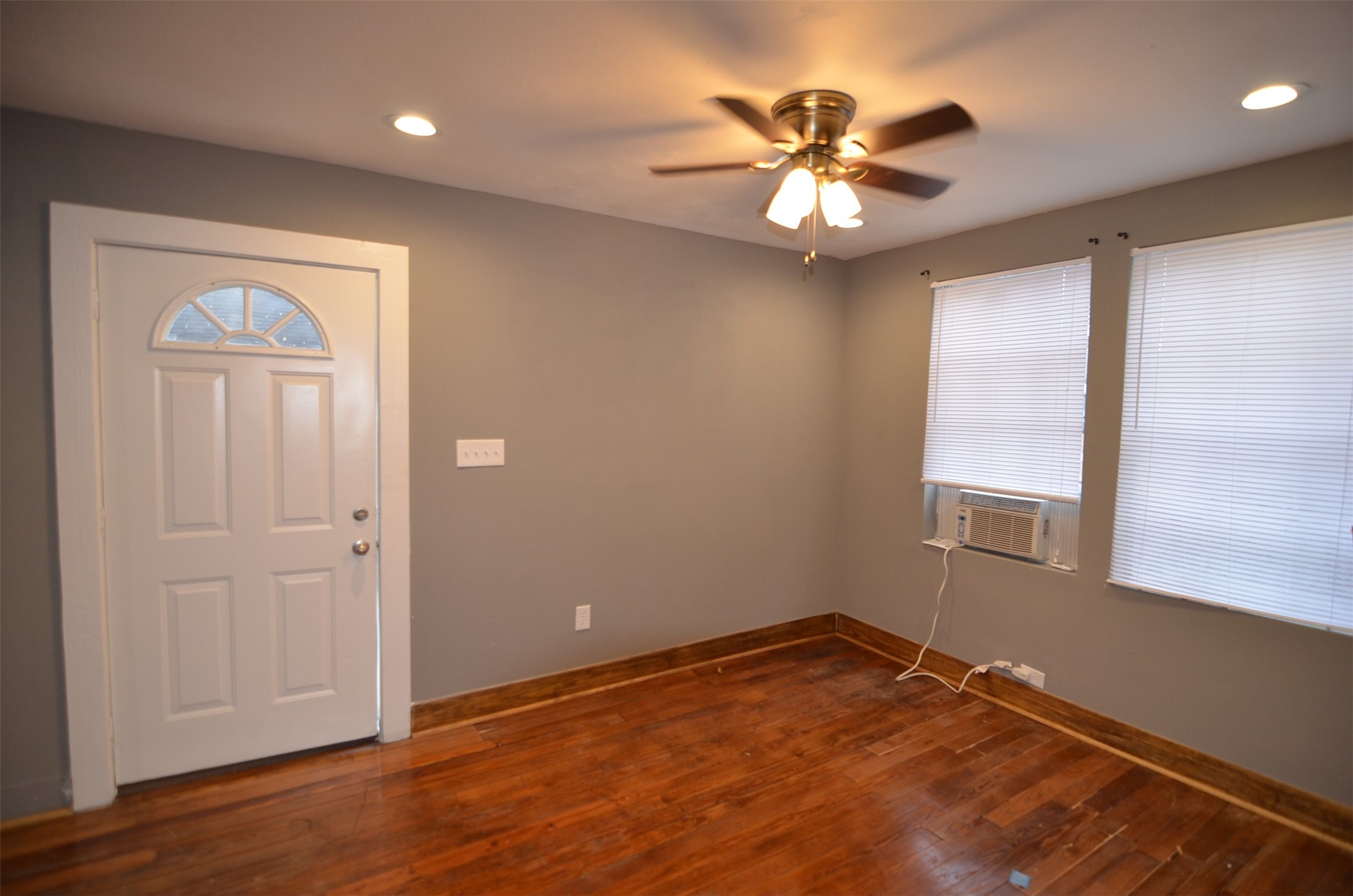 2123 Marion Street, Unit 1 Houston, TX 77009 - Photo 8 of 19 wooden floor in an empty room with a window