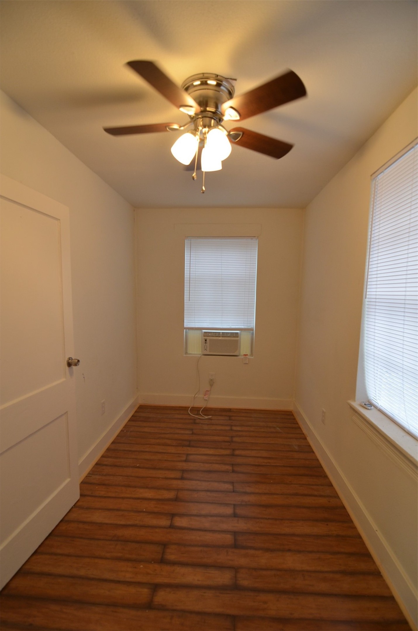 2123 Marion Street, Unit 1 Houston, TX 77009 - Photo 9 of 19 a view of an empty room with wooden floor and a window