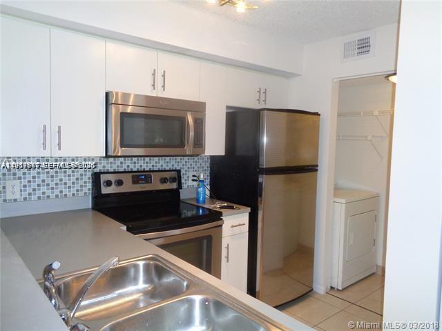 650 South Park Road, Unit 215 Hollywood, FL 33021 - Photo 2 of 24 a kitchen with a refrigerator stove and microwave