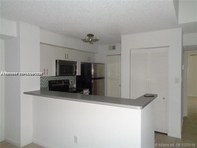 650 South Park Road, Unit 215 Hollywood, FL 33021 - Photo 3 of 24 a kitchen with stainless steel appliances a refrigerator and microwave