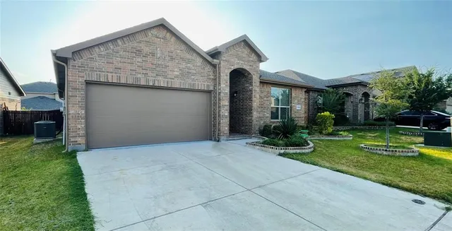 a front view of house with a garden
