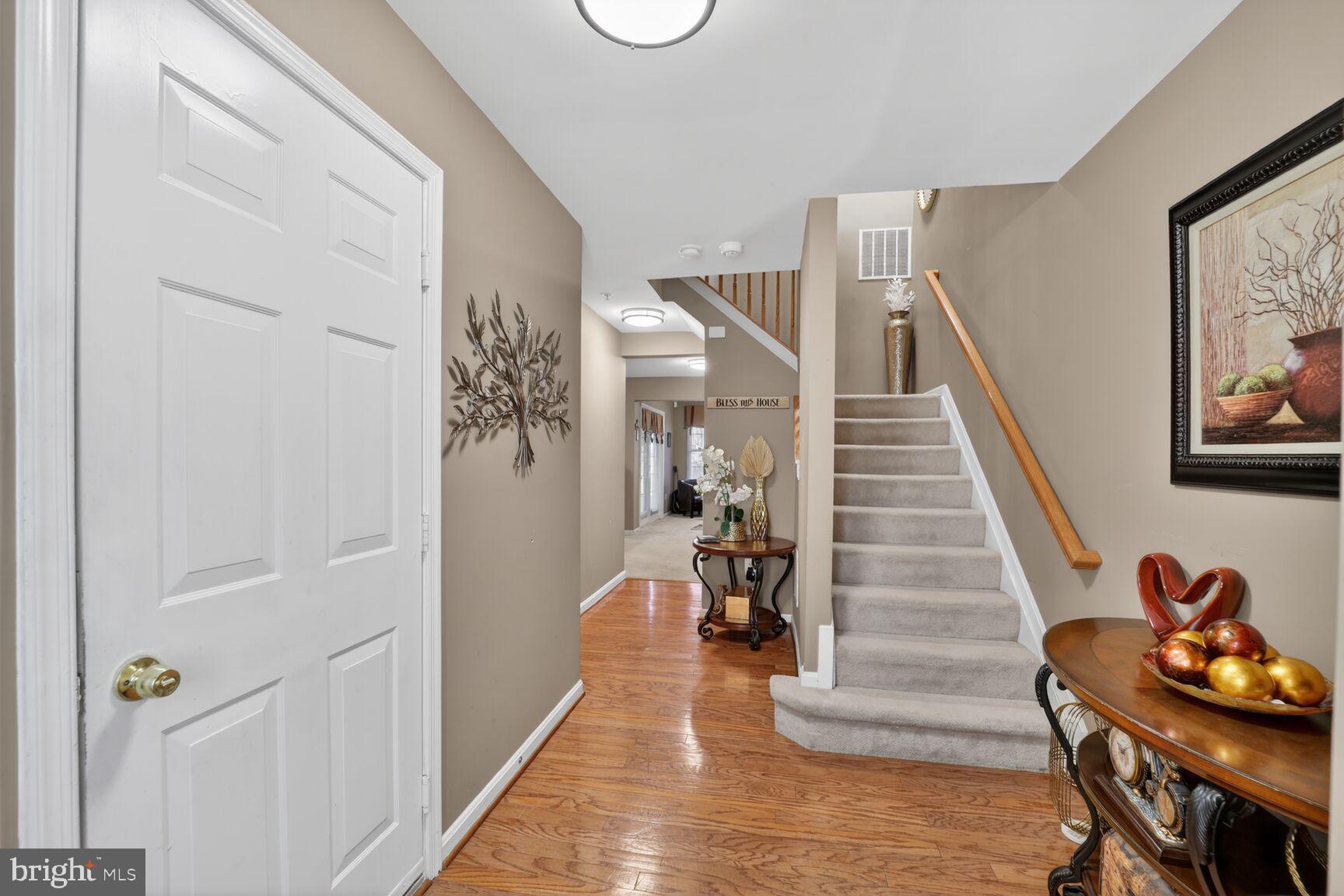 165 Tilden Way Edgewater, MD 21037 - Photo 5 of 22 a view of a hallway with wooden floor and stairs