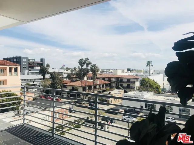 a bathroom with a granite countertop sink and a toilet